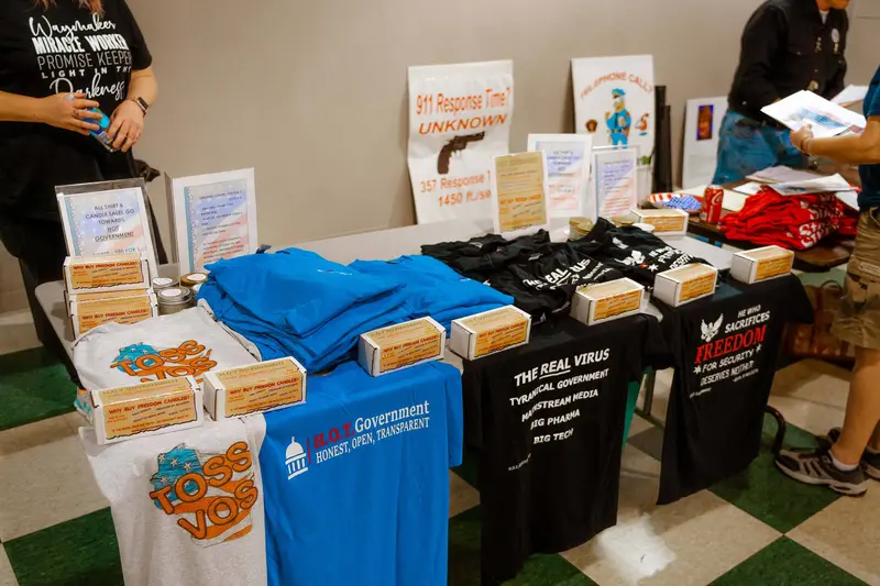 T-shirts bearing slogans like "toss Vos" and "the REAL virus: tyrannical government, mainstream media, big pharma, big tech."